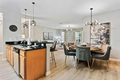 a kitchen and dining room with a table and chairs at 4804 Cayview Ave #105 in Orlando