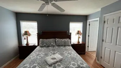 a bedroom with a bed and a ceiling fan at Your Oasis Awaits! Indulge at Florida Hideaways 4BD Pool Home in Kissimmee