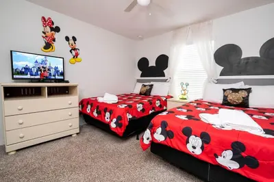 a bedroom with two beds with mickey mouse beds at 8937CP-SVH in Kissimmee