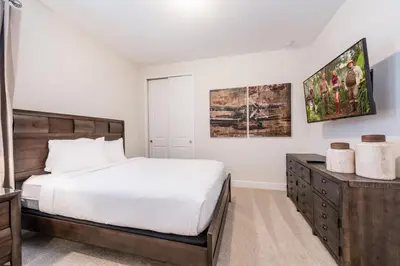 a bedroom with a large bed and a dresser at Elegant Home Near Disney With Private Pool And Waterpark & Resort Access At Encore Resorts Reunion - 7393Mr in Kissimmee