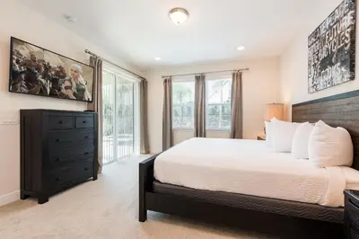 a bedroom with a large bed and windows at Elegant Home Near Disney With Private Pool And Waterpark & Resort Access At Encore Resorts Reunion - 7393Mr in Kissimmee