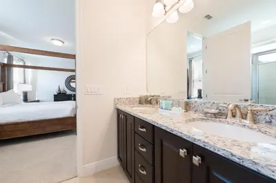 a bathroom with a sink and a large mirror at Elegant Home Near Disney With Private Pool And Waterpark & Resort Access At Encore Resorts Reunion - 7393Mr in Kissimmee
