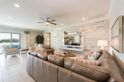 a living room with a large couch and a tv at Exquisite Home With Theater, Themed Rooms Near Disney With Waterpark & Resort Access At Encore Resort- 7664Ff in Kissimmee