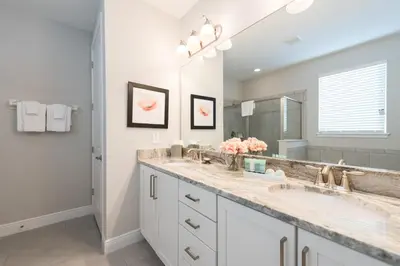 a bathroom with two sinks and a large mirror at Exquisite Home With Theater, Themed Rooms Near Disney With Waterpark & Resort Access At Encore Resort- 7664Ff in Kissimmee