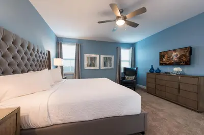 a bedroom with a white bed and a ceiling fan at Exquisite Home With Theater, Themed Rooms Near Disney With Waterpark & Resort Access At Encore Resort- 7664Ff in Kissimmee