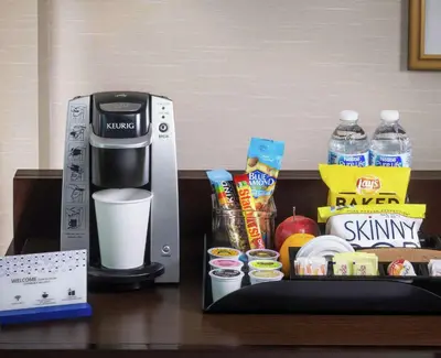 a coffee maker and some food on a table at Hampton Inn & Suites Orlando Airport at Gateway Village in Orlando