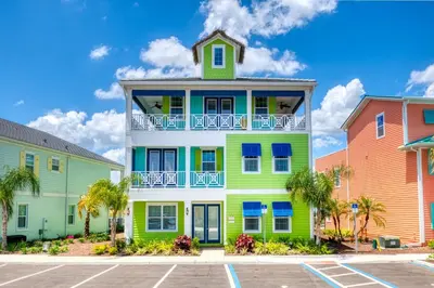 a colorful building in a parking lot with colorful houses at Margaritaville Cottages Orlando by Rentyl with H2O Waterpark in Kissimmee