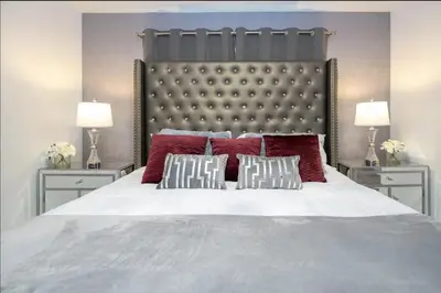 a bedroom with a large white bed with red pillows at Storey Lake Resort Just 5 Minutes to Mickey Mouse in Kissimmee