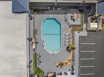 an overhead view of a swimming pool next to a building at Baymont by Wyndham Orlando East in Orlando