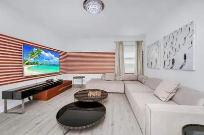 a living room with a white couch and a piano at Striking Home With Games, Outdoor Kitchen Near Disney With Waterpark & Resort Access At Encore Resort - 7742Ff in Kissimmee