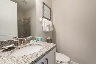 a bathroom with a sink and a toilet at Delightful Home Near Disney With Private Pool, Media Room, Waterpark & Resort Access At Encore Resort Reunion - 7418Mr in Kissimmee
