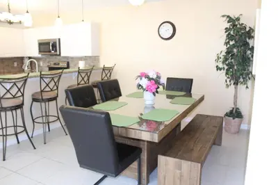 a dining room table with a vase of flowers on it at Crayson Villa LF811 in Kissimmee