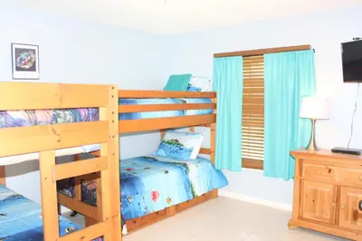 a bedroom with two bunk beds and a television at Crayson Villa LF811 in Kissimmee