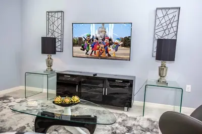 a living room with a flat screen tv on a wall at Four Bedroom Close to Disney 5149A in Kissimmee