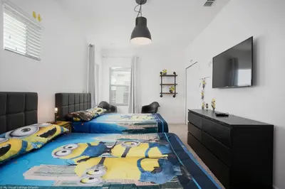a bedroom with two beds and a flat screen tv at Sonoma Resort 7 Bedroom Home with Pool 1849 in Kissimmee