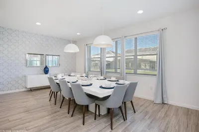 a dining room with a white table and chairs at Sonoma Resort 7 Bedroom Home with Pool 1849 in Kissimmee