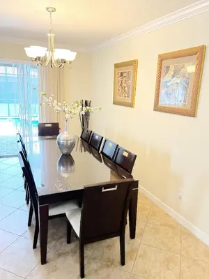 a dining room with a black table and chairs at DWS Vacation Villas in Orlando