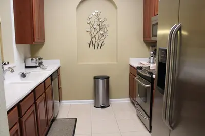 a kitchen with a stainless steel refrigerator and a sink at Viz Cay Apartment 202 in Orlando