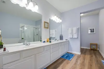 a bathroom with two sinks and a large mirror at Casa Magna Condo #152742 in Orlando