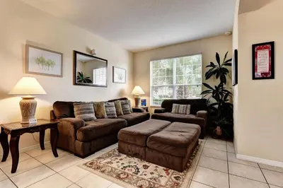 a living room with a couch and a table at Margaritavilla at Emerald Island in Kissimmee