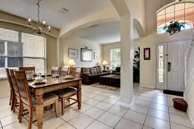 a dining room and living room with a table at Margaritavilla at Emerald Island in Kissimmee