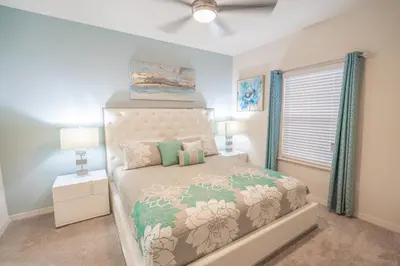 a bedroom with a bed and a ceiling fan at Dream Vacation Home! in Kissimmee