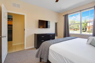 a bedroom with a bed and a tv on the wall at Scarlet in Orlando