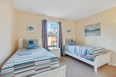 a bedroom with two beds and a window at Scarlet in Orlando