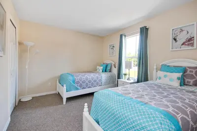 a bedroom with two beds and a window at Scarlet in Orlando