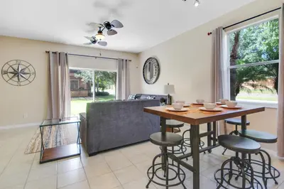 a living room with a table and a couch at Scarlet in Orlando
