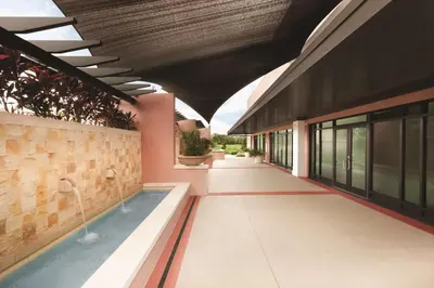a building with a pool in the middle of a building at Embassy Suites by Hilton Orlando Lake Buena Vista South in Kissimmee