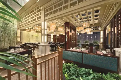 a rendering of a restaurant with tables and chairs at Embassy Suites by Hilton Orlando Lake Buena Vista South in Kissimmee