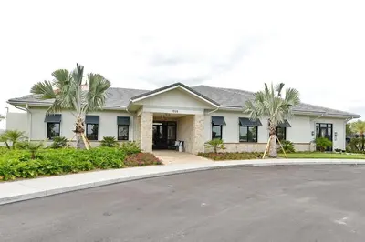 a house with palm trees in front of a driveway at 3083 TS-SVH Storey Lake in Kissimmee