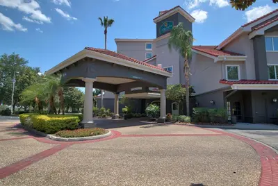 a hotel with a gazebo in front of a building at La Quinta by Wyndham Orlando I Drive/Conv Center in Orlando
