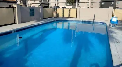 a large blue swimming pool on top of a building at Baymont by Wyndham Orlando South in Orlando