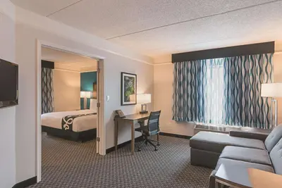 a hotel room with a bed and a desk at La Quinta by Wyndham Orlando UCF in Orlando