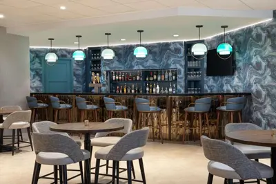 a restaurant with tables and chairs and a bar at DoubleTree Suites by Hilton Orlando at Disney Springs in Orlando