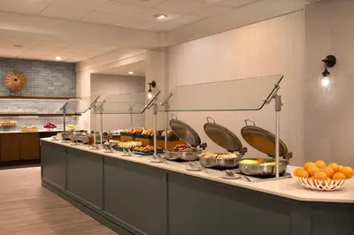 a buffet line in a restaurant with food on it at DoubleTree Suites by Hilton Orlando at Disney Springs in Orlando
