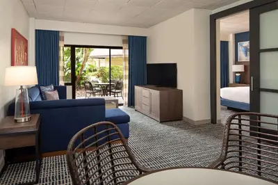 a hotel room with a couch and a bed at DoubleTree Suites by Hilton Orlando at Disney Springs in Orlando