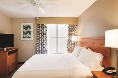 a hotel room with a bed and a television at Homewood Suites by Hilton Orlando-International Drive Convention Center in Orlando