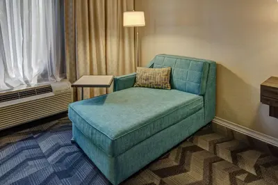 a living room with a blue chair in a hotel room at Hampton Inn & Suites Clermont in Clermont