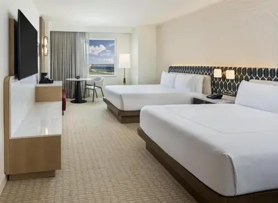 a hotel room with two beds and a table at Hilton Orlando in Orlando