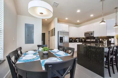 a dining room and kitchen with a table and chairs at Silver Creek - 3 Bed Townhouse Wsplashpool-5003Sc in Orlando