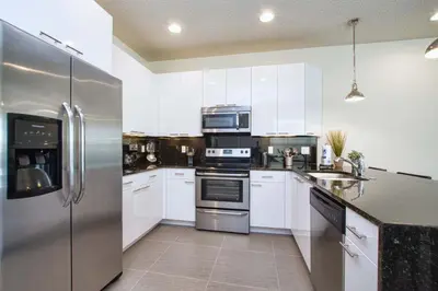 a kitchen with white cabinets and stainless steel appliances at Silver Creek - 3 Bed Townhouse Wsplashpool-5003Sc in Orlando