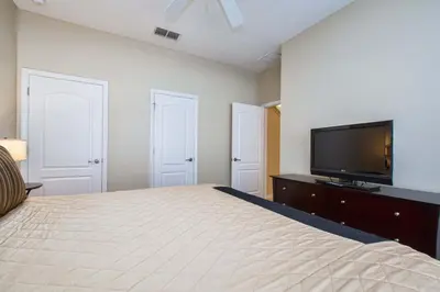 a bedroom with a bed and a flat screen tv at Paradise Palms-4 Bed Townhome W-Splashpool-3044Ppr in Kissimmee