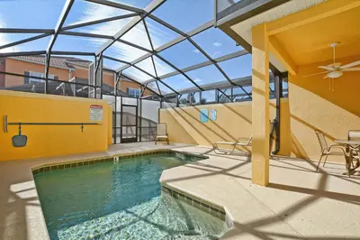 a swimming pool with a glass roof on a building at Paradise Palms-4 Bed Townhome W-Splashpool-3044Ppr in Kissimmee