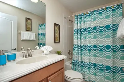 a bathroom with a shower with a sink and a toilet at Paradise Palms- 6 Bedroom Pool Home-3150Pp in Kissimmee