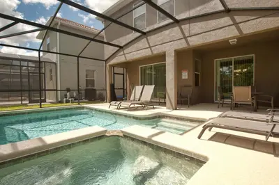 a swimming pool with a patio and a house at Paradise Palms- 6 Bedroom Pool Home-3150Pp in Kissimmee