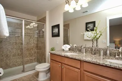 a bathroom with a toilet and a sink and a shower at Paradise Palms- 6 Bedroom Pool Home-3150Pp in Kissimmee