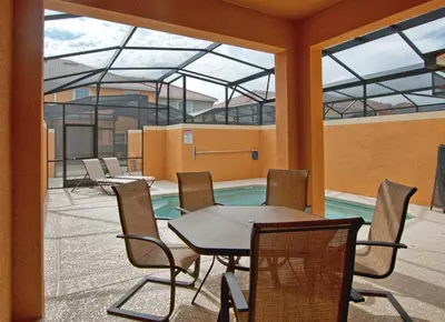 a cafeteria with a table and chairs and a pool at Dog-Friendly Townhome Wsplashpool -3201Pp in Kissimmee